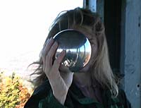 Video frame of Lauren with the sphere at the top of a fire tower